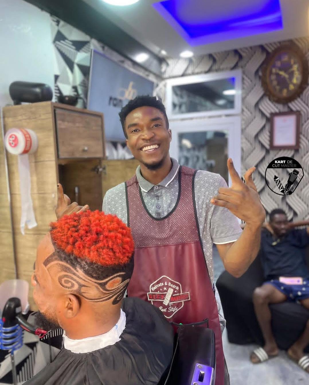 Barber at work with creative hair art at Kart Master 700